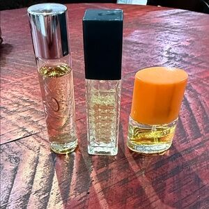 Set of Three Perfume Bottles with Silver, Black, and Orange Caps